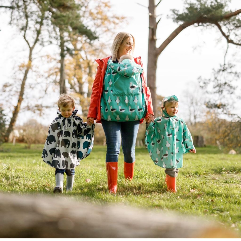 BundleBean Babywearing fleece-lined and waterproof cover in seagull design with toddlers in seagull and elephant ponchos