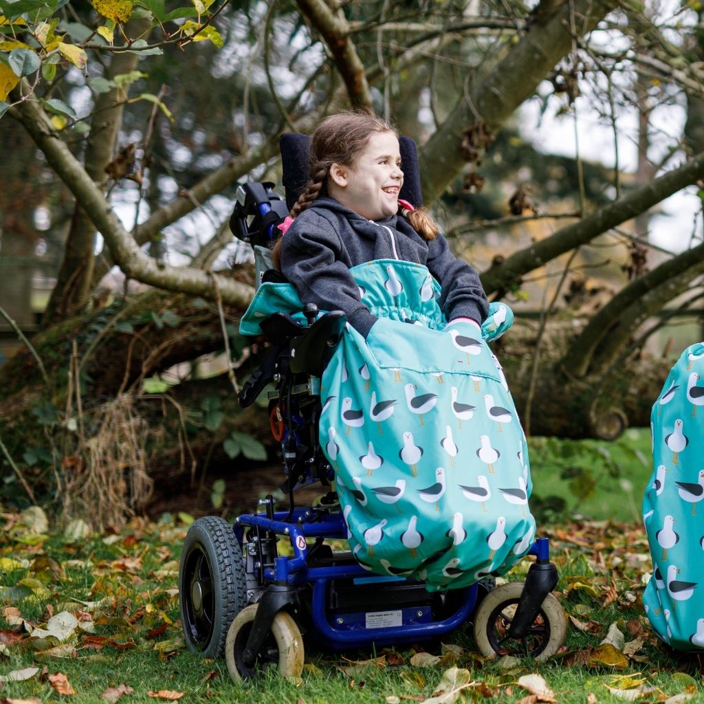 Kids fleece-lined wheelchair cosies. Waterproof, warm and easy to fit. Seen here in a seagulls design.