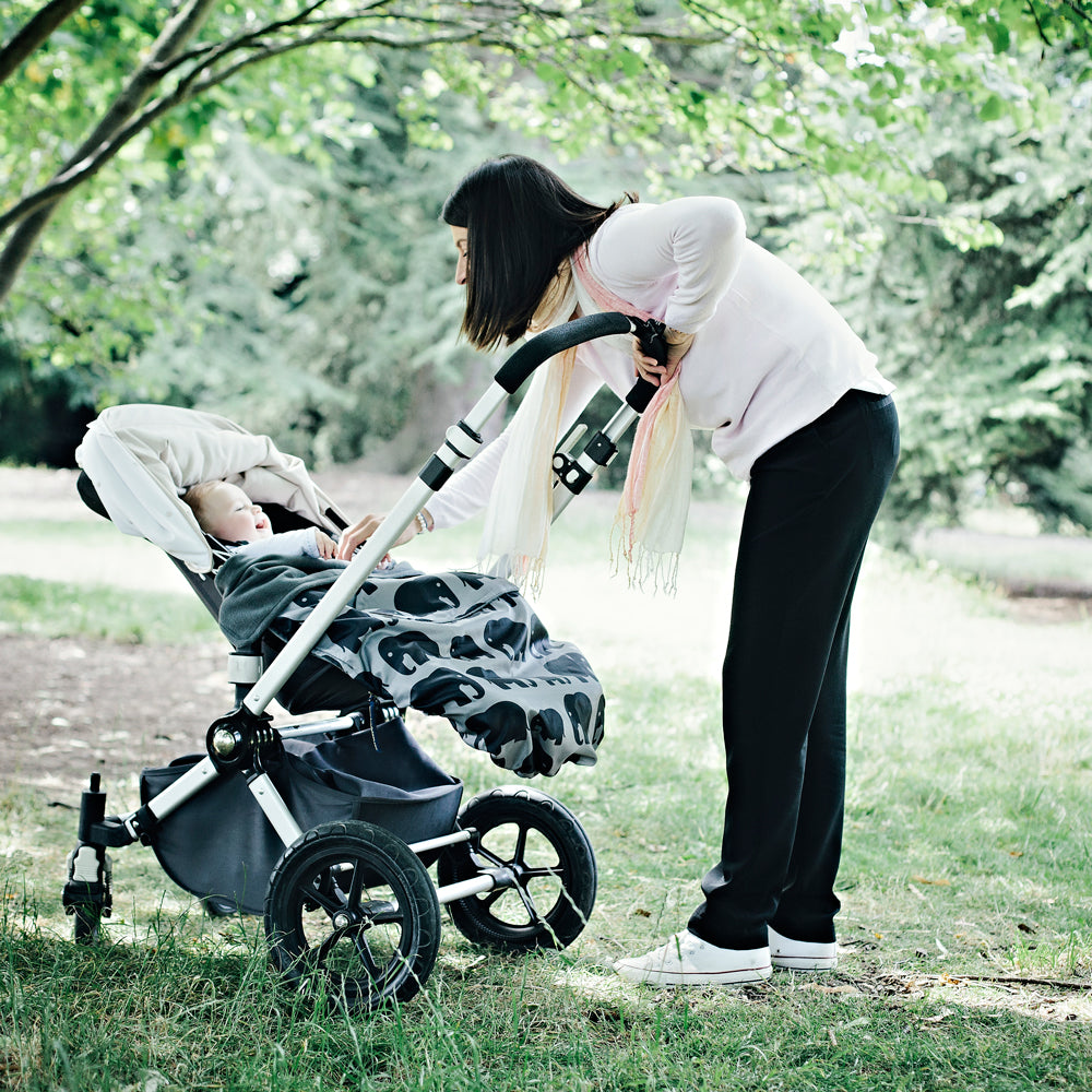 The BundleBean GO is a waterproof footmuff for babies and toddlers that fits snugly on to buggies, bike seats, car seats and baby carriers. Seen here on a pushchair and in an elephant design