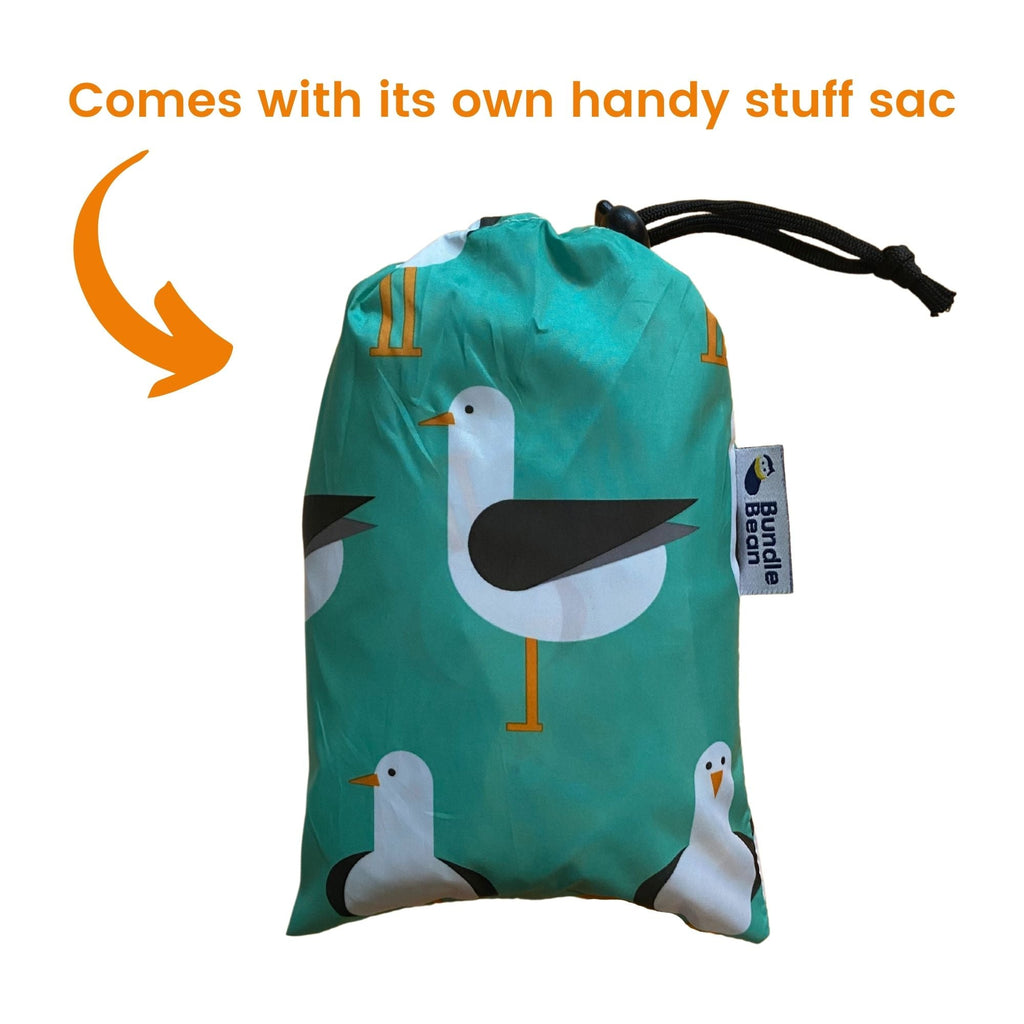 Kids Wheelchair poncho - easy to put on, fully waterproof and with peaked hood to protect faces from the rain. Seen here in its own handy stuff sac.