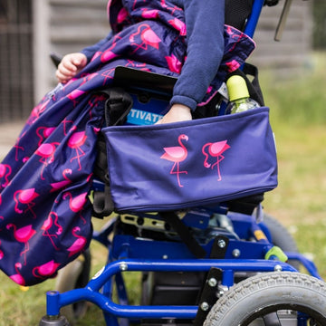 These handy wheelchair organiser bags fit on all wheelchairs, powerchairs, special needs buggies and rollators. Seen here in a pink flamingo design.