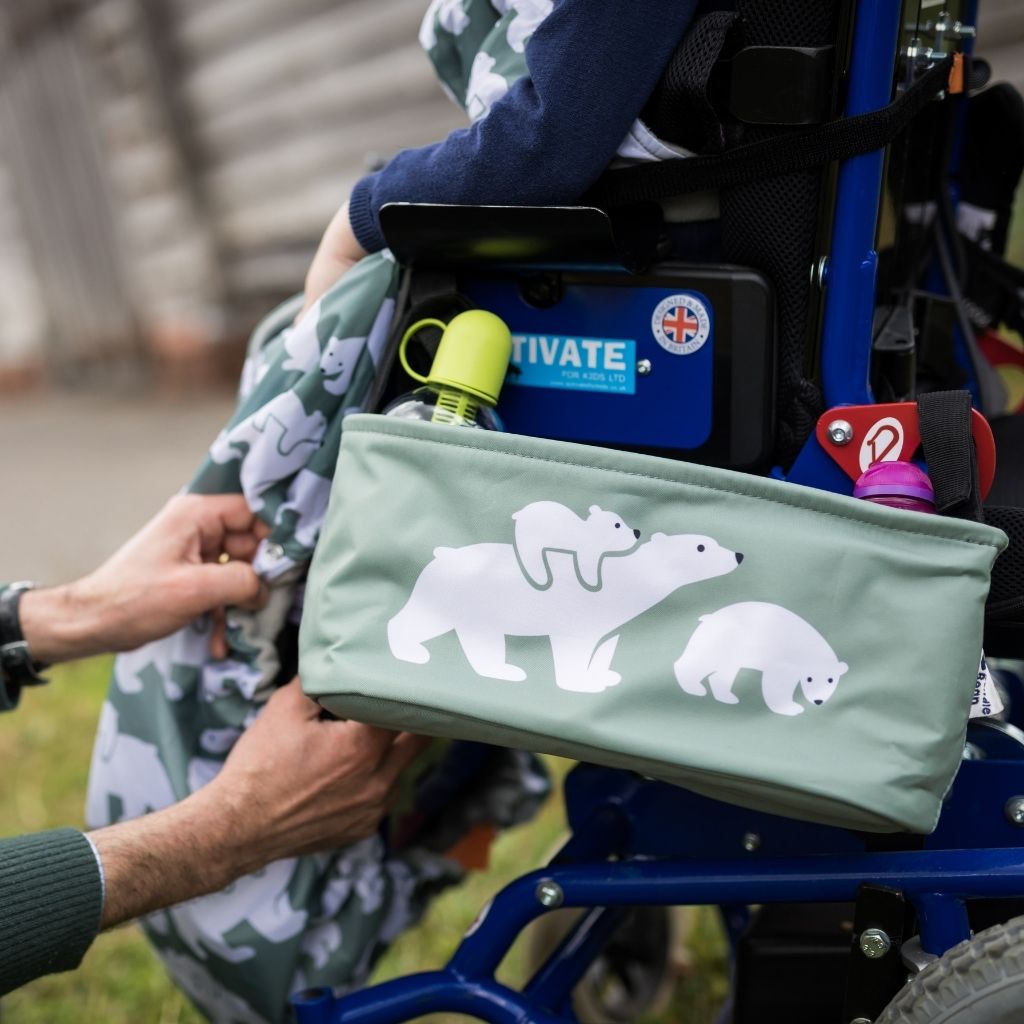 These handy wheelchair organiser bags fit on all wheelchairs, powerchairs, special needs buggies and rollators. Seen here in a polar bear design.