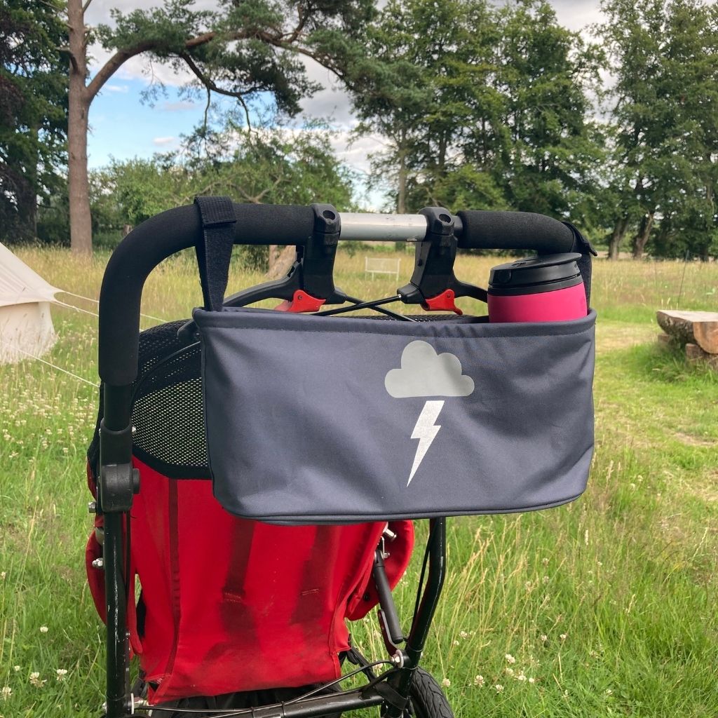 These handy wheelchair organiser bags fit on all wheelchairs, powerchairs, special needs buggies and rollators. Seen here in a silver lightning design.