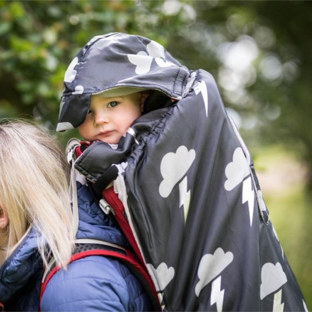 BundleBean Babywearing fleece-lined and waterproof cover with hood in silver lightning design seen here on a backpack