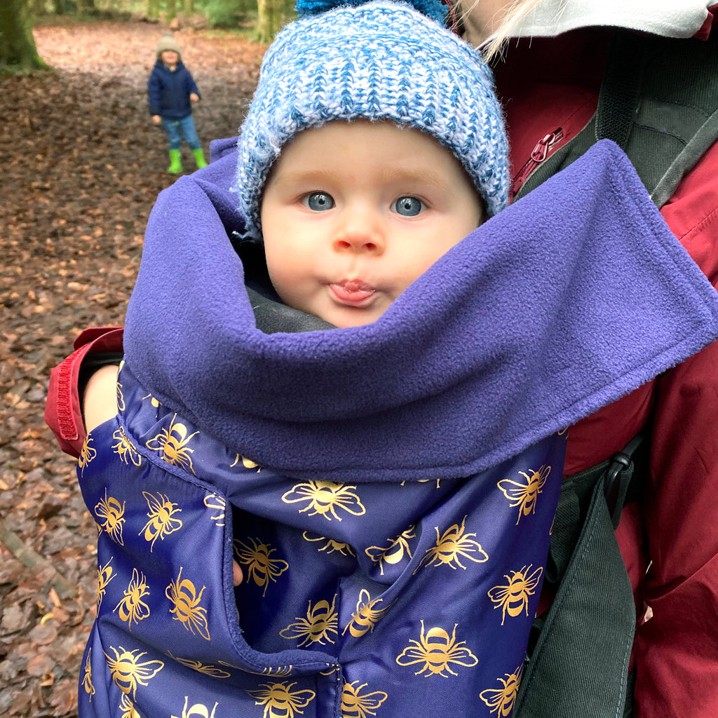 The BundleBean GO is a waterproof footmuff for babies and toddlers that fits snugly on to buggies, bike seats, car seats and baby carriers. Seen here in a bee design.
