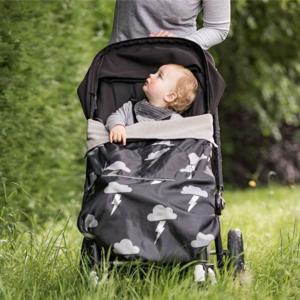 The BundleBean GO is a waterproof footmuff for babies and toddlers that fits snugly on to buggies, bike seats, car seats and baby carriers. Seen here on a pushchair and in a silver lightning design.