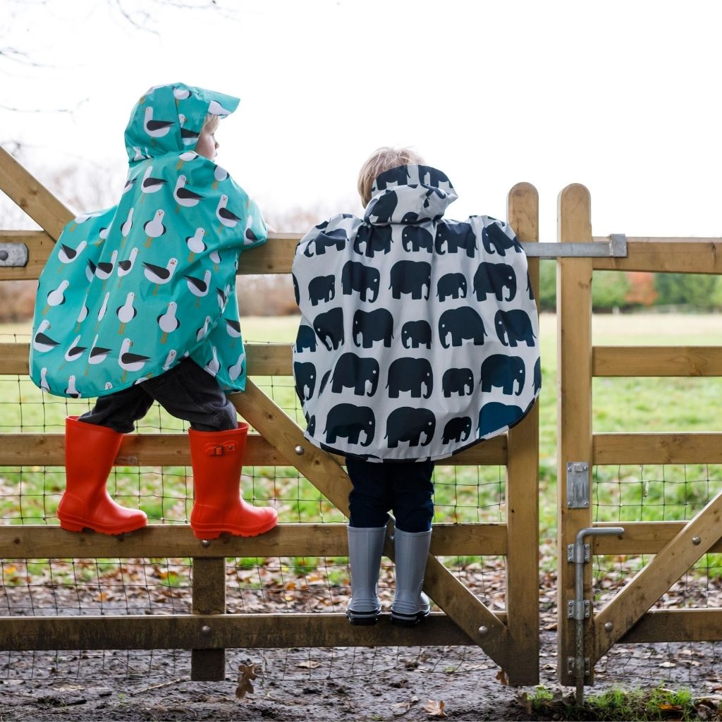 Toddler ponchos for 2-4 years old. A raincover that's easy to pop on and fully waterproof and with a peaked hood to protect little faces. Seen here in a seagull and an elephant design.