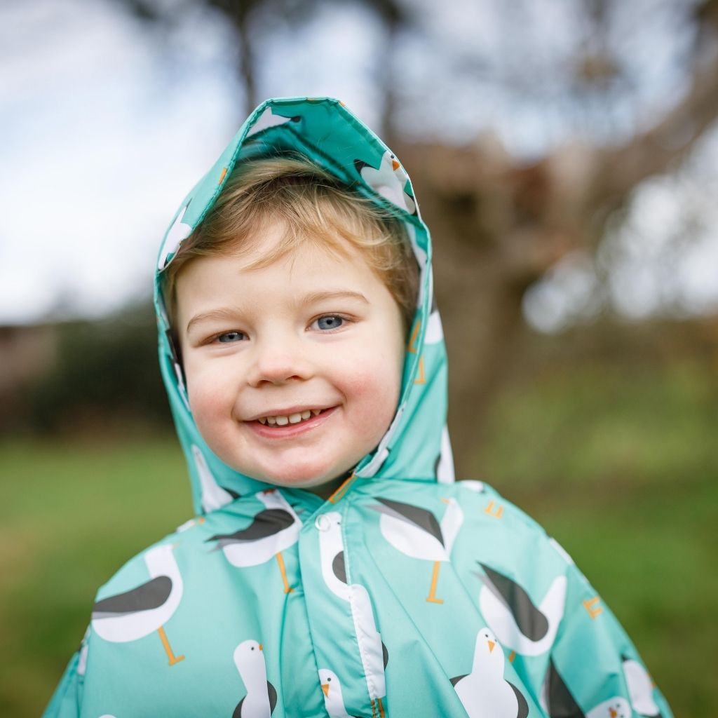 Toddler ponchos for 2-4 years old. A raincover that's easy to pop on and fully waterproof and with a peaked hood to protect little faces. Seen here in a seagull design.
