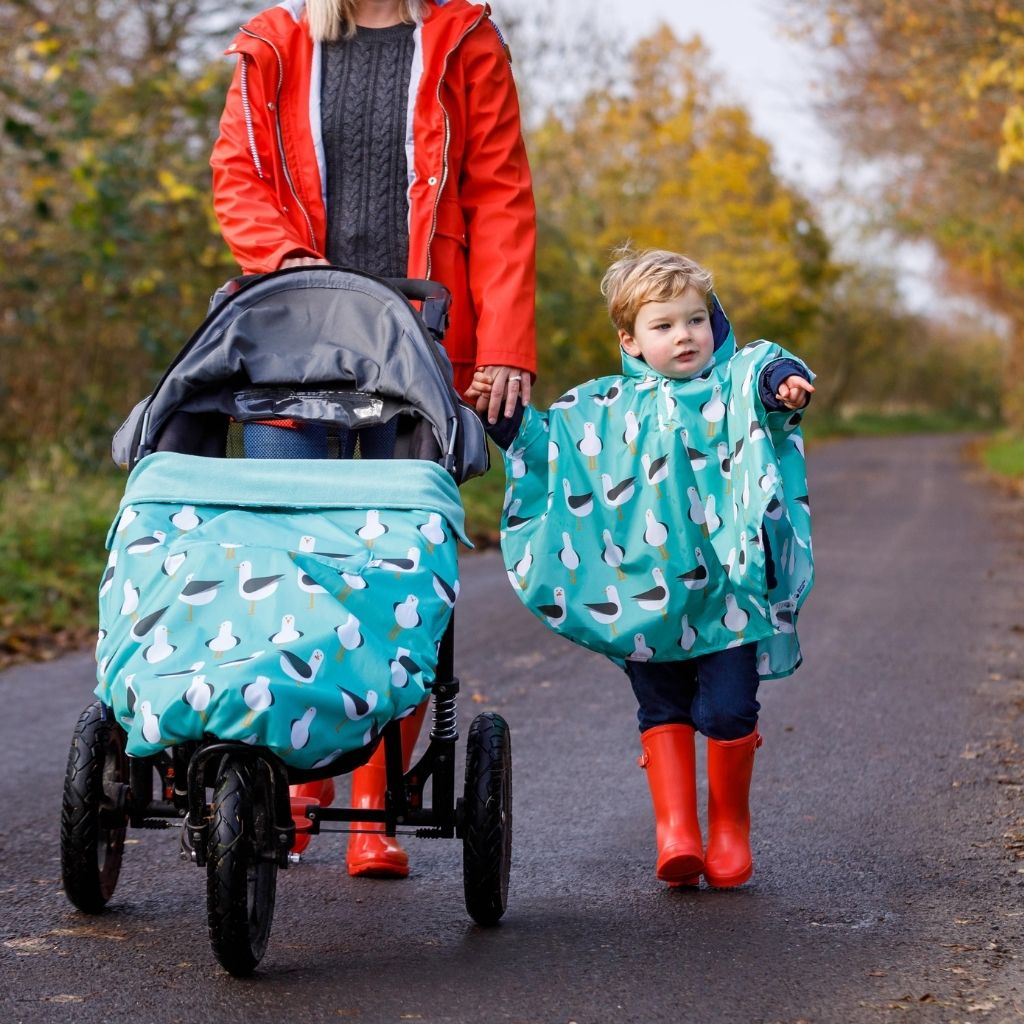 Toddler ponchos for 2-4 years old. A raincover that's easy to pop on and fully waterproof and with a peaked hood to protect little faces. Seen here in a seagull design. matching with the BundleBean GO on the pushchair.