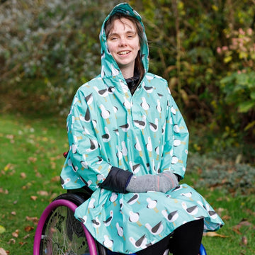 Fully waterproof adult wheelchair poncho with a peaked hood to protect faces from the rain. In seagull design.