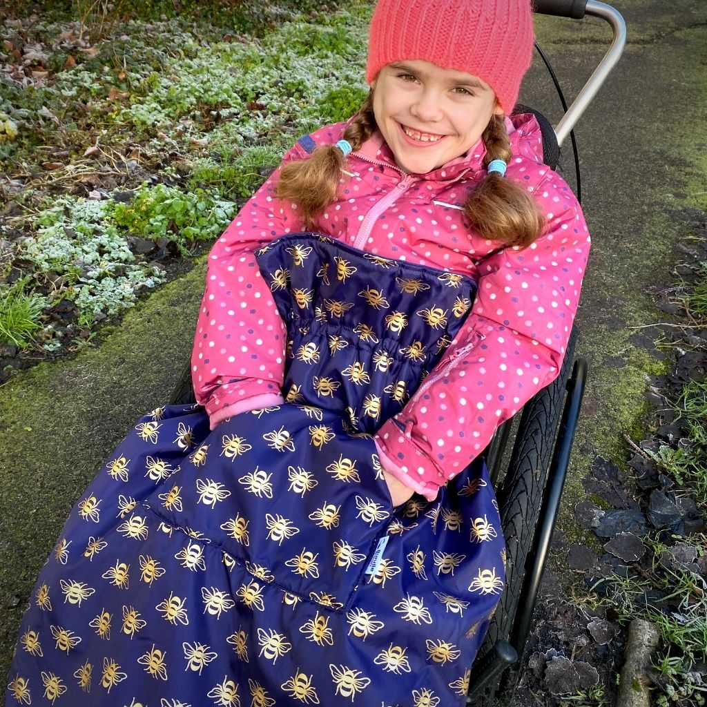 Kids fleece-lined wheelchair cosies. Waterproof, warm and easy to fit. Seen here in a gold bee design.