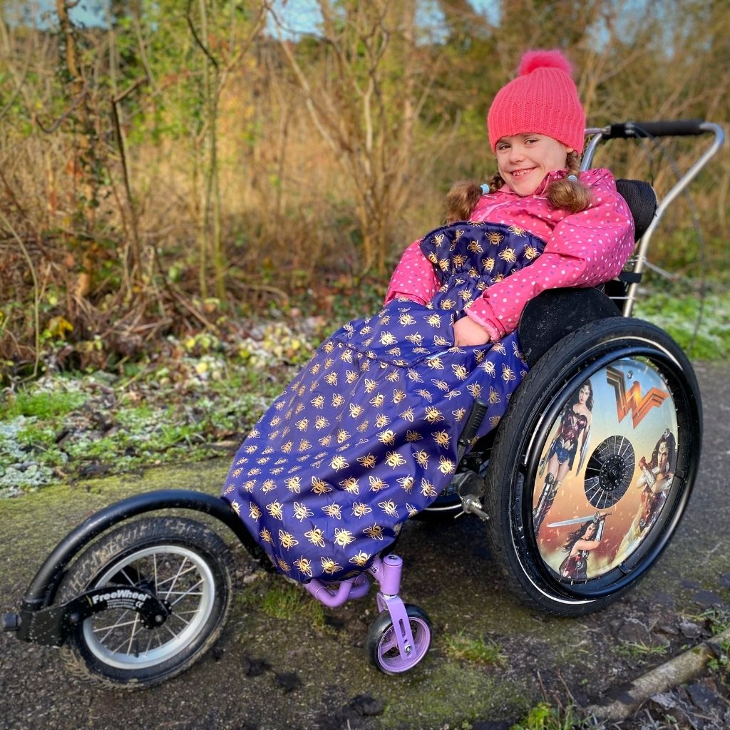Kids fleece-lined wheelchair cosies. Waterproof, warm and easy to fit. Seen here in a gold bee design.