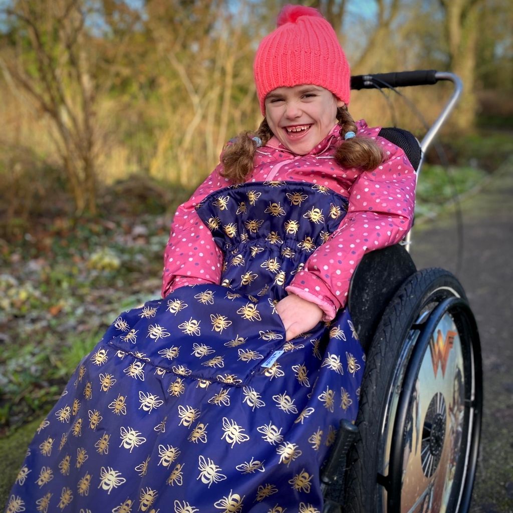 Kids fleece-lined wheelchair cosies. Waterproof, warm and easy to fit. Seen here in a gold bee design.