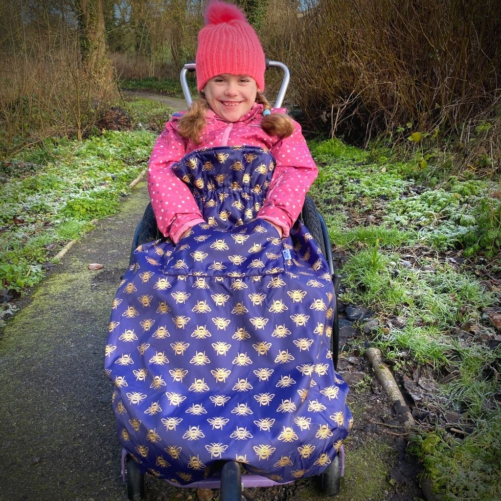 Kids fleece-lined wheelchair cosies. Waterproof, warm and easy to fit. Seen here in a gold bee design.