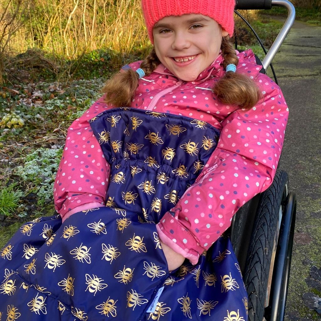 Kids fleece-lined wheelchair cosies. Waterproof, warm and easy to fit. Seen here in a gold bee design.