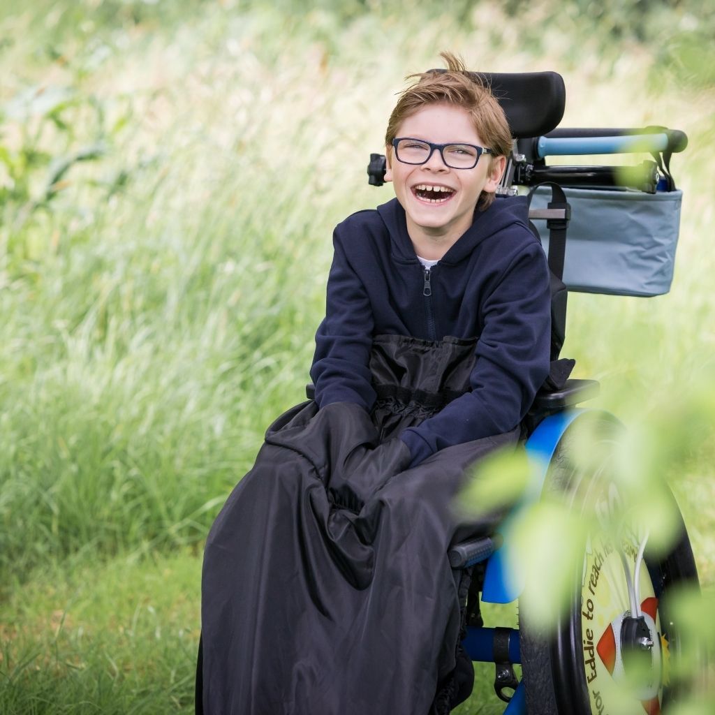 Kids fleece-lined wheelchair cosies. Waterproof, warm and easy to fit. Seen here in black.