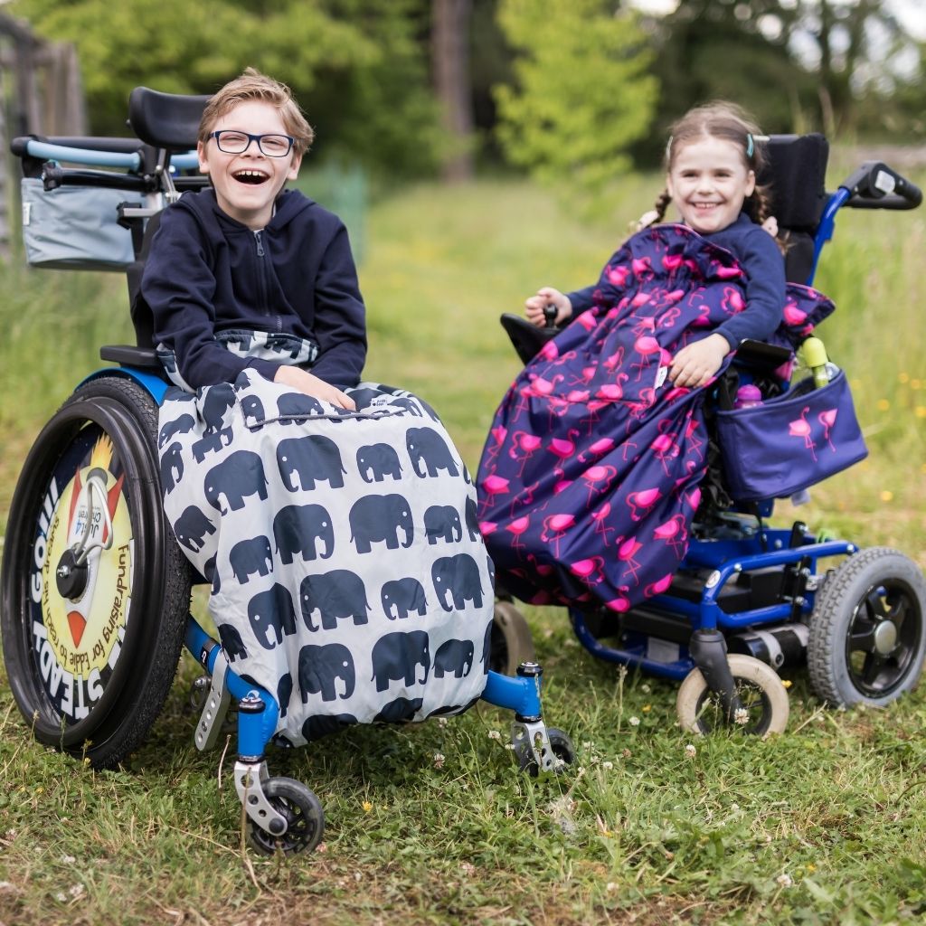 Kids fleece-lined wheelchair cosies. Waterproof, warm and easy to fit. Seen here in an elephant and flamingo design