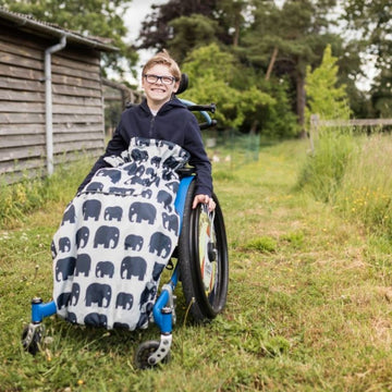 Kids fleece-lined wheelchair cosies. Waterproof, warm and easy to fit. Seen here in an elephant design.