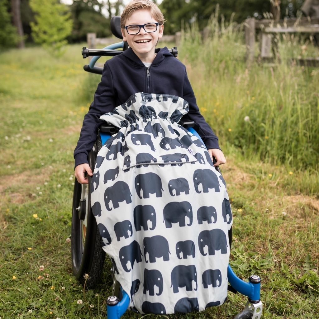 Kids fleece-lined wheelchair cosies. Waterproof, warm and easy to fit. Seen here in an elephant design.