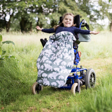 Kids fleece-lined wheelchair cosies. Waterproof, warm and easy to fit. Seen here in a polar bear design.