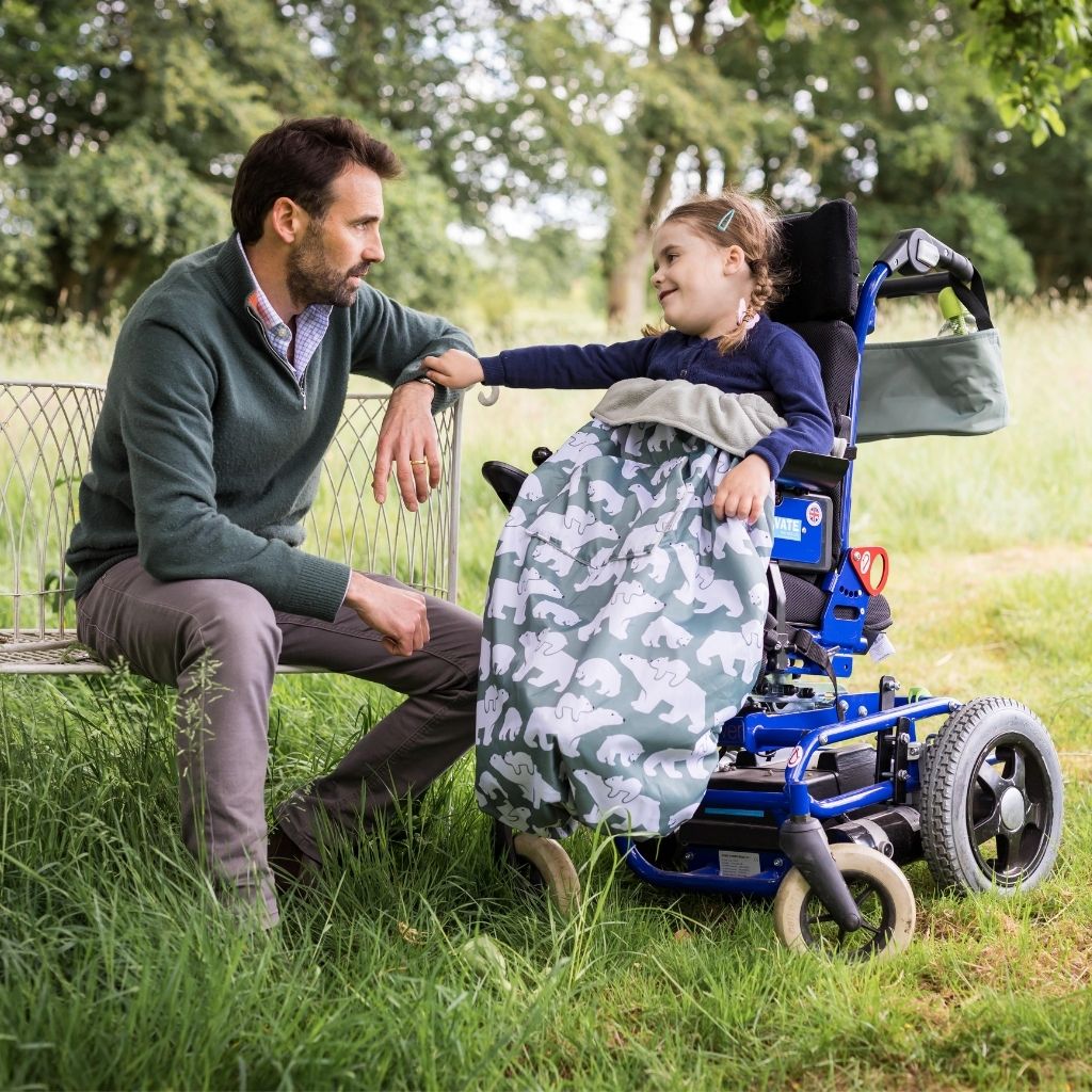 Kids fleece-lined wheelchair cosies. Waterproof, warm and easy to fit. Seen here in a polar bear design.