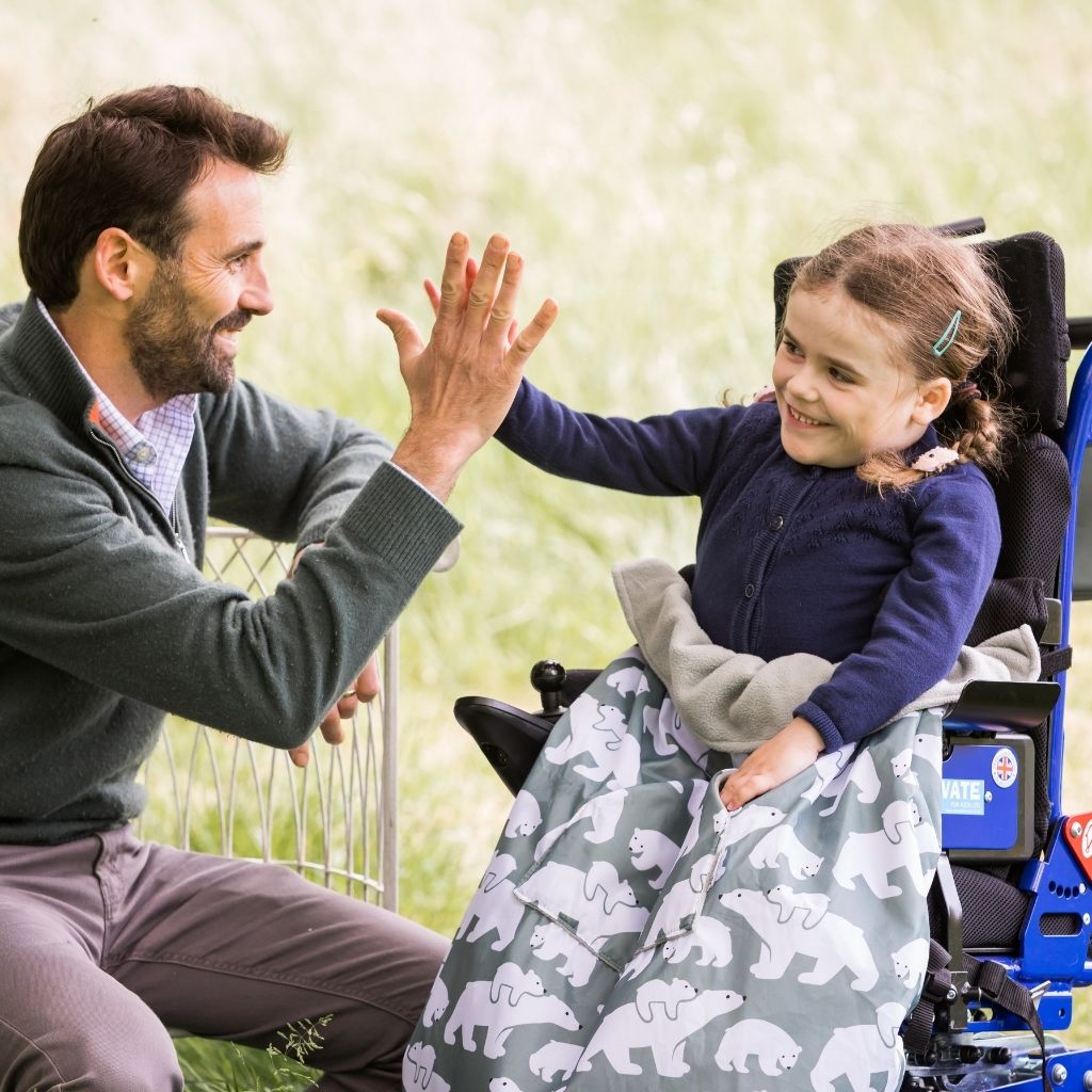 Kids fleece-lined wheelchair cosies. Waterproof, warm and easy to fit. Seen here in a polar bear design.