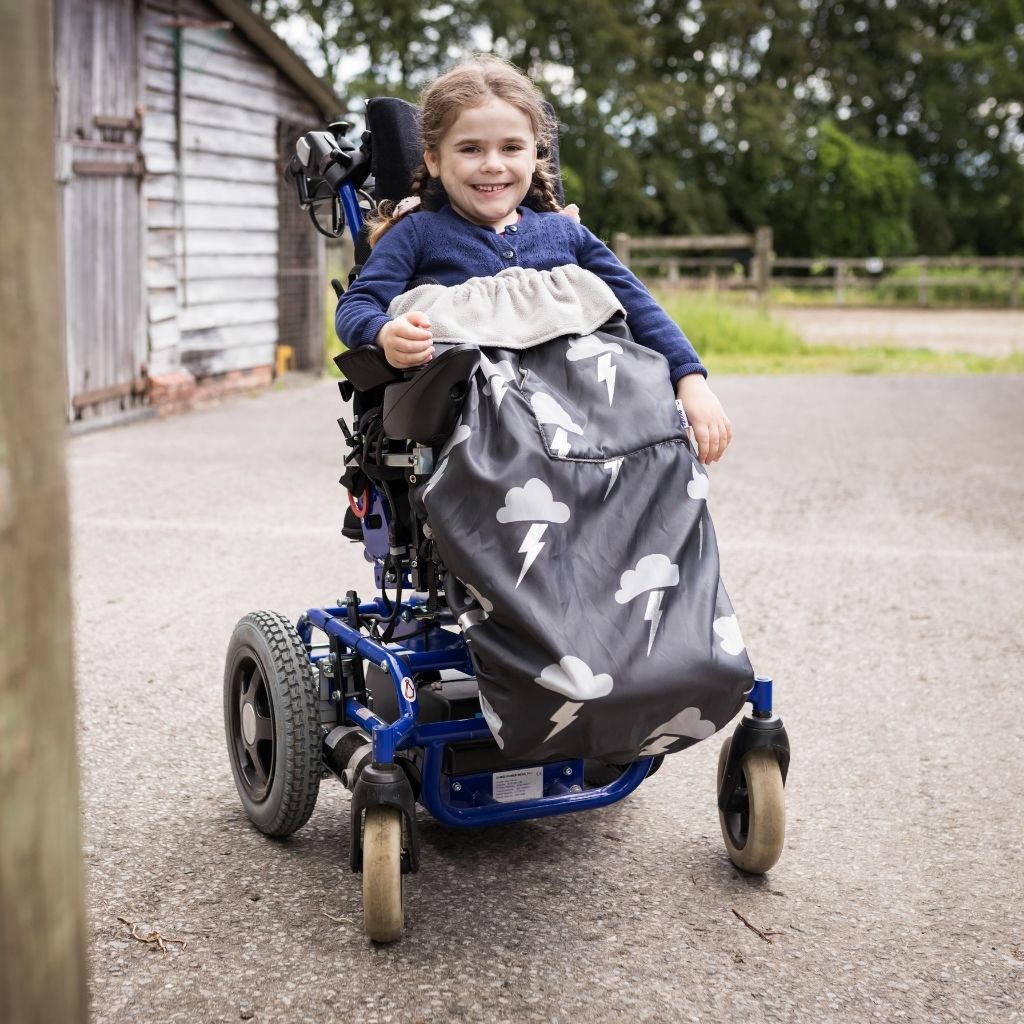 Kids fleece-lined wheelchair cosies. Waterproof, warm and easy to fit. Seen here in a silver lightning design.