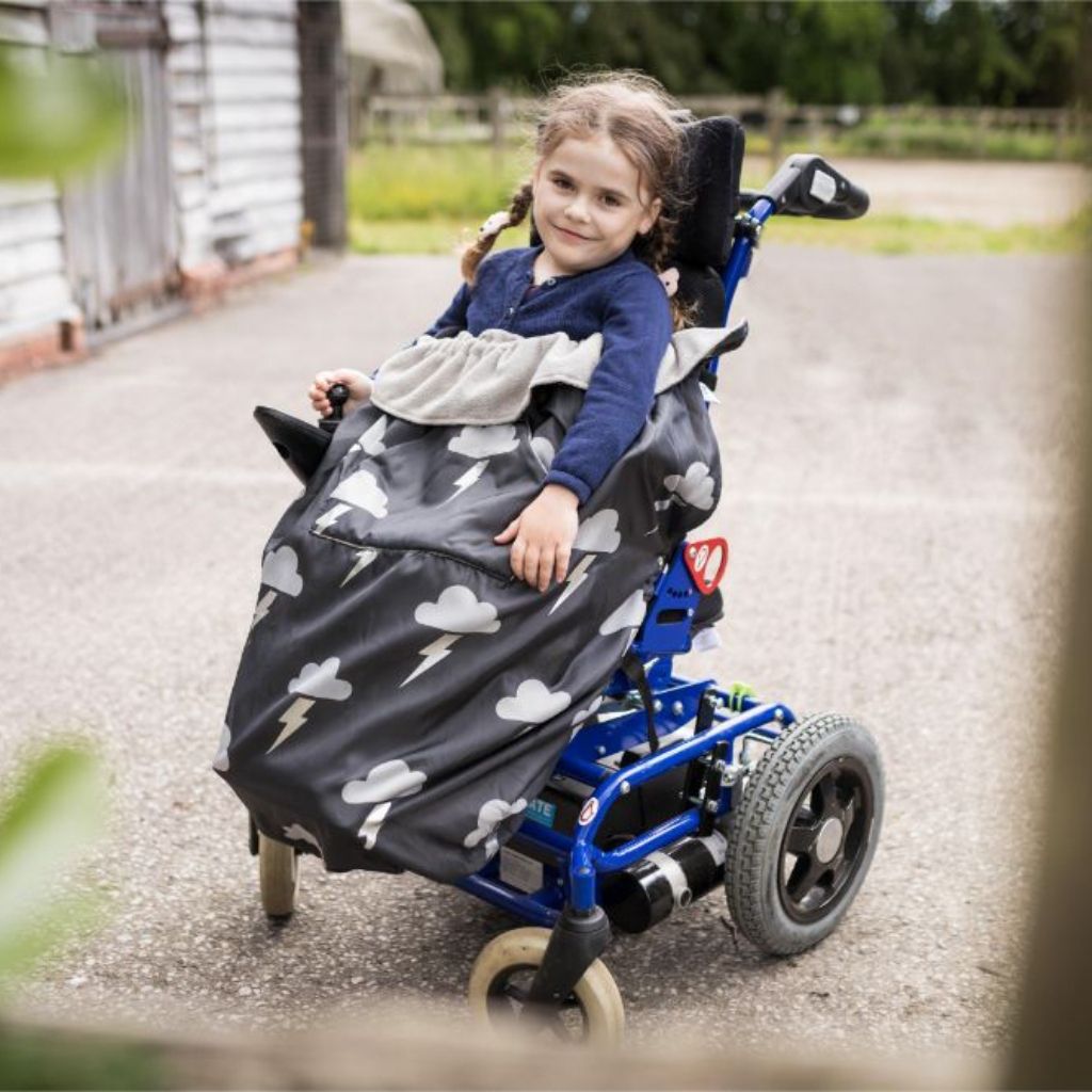 Kids fleece-lined wheelchair cosies. Waterproof, warm and easy to fit. Seen here in a silver lightning design.