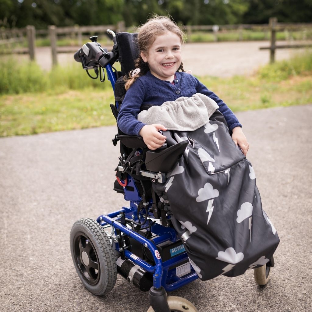 Kids fleece-lined wheelchair cosies. Waterproof, warm and easy to fit. Seen here in a silver lightning design.