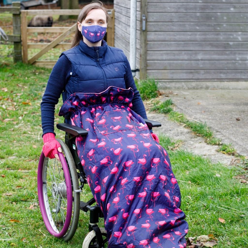 BundleBean Adult fleece-lined and waterproof wheelchair cosy in flamingo design with matching flamingo face mask