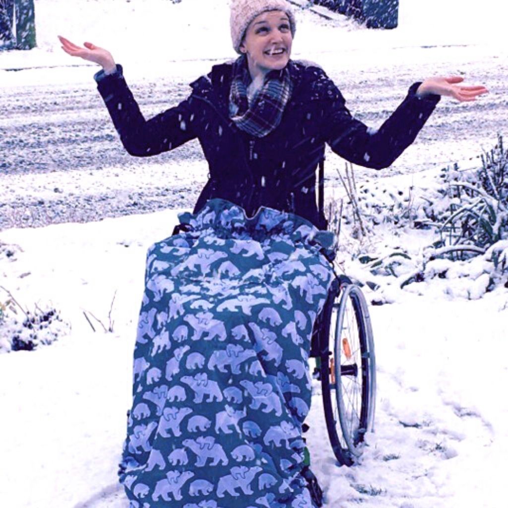 Kate Stanforth keeping cosy in the snow in Bundlebean's Adult fleece-lined and waterproof wheelchair cosy in a polar bear design.