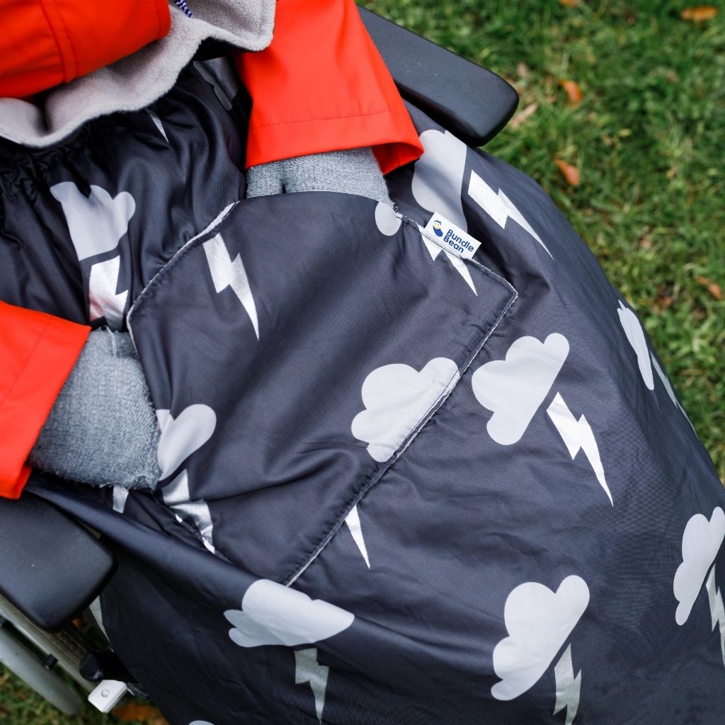BundleBean Adult fleece-lined and waterproof wheelchair cosy in silver lightning design with handy front pocket to keep hands warm.
