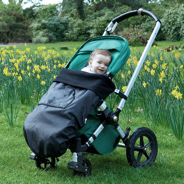 The BundleBean GO is a waterproof footmuff for babies and toddlers that fits snugly on to buggies, bike seats, car seats and baby carriers. Seen here on a pushchair and in black.