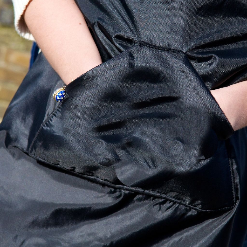 The BundleBean GO is a waterproof footmuff for babies and toddlers that fits snugly on to buggies, bike seats, car seats and baby carriers. Seen here on a pushchair and in black. showing the hand warming pocket.