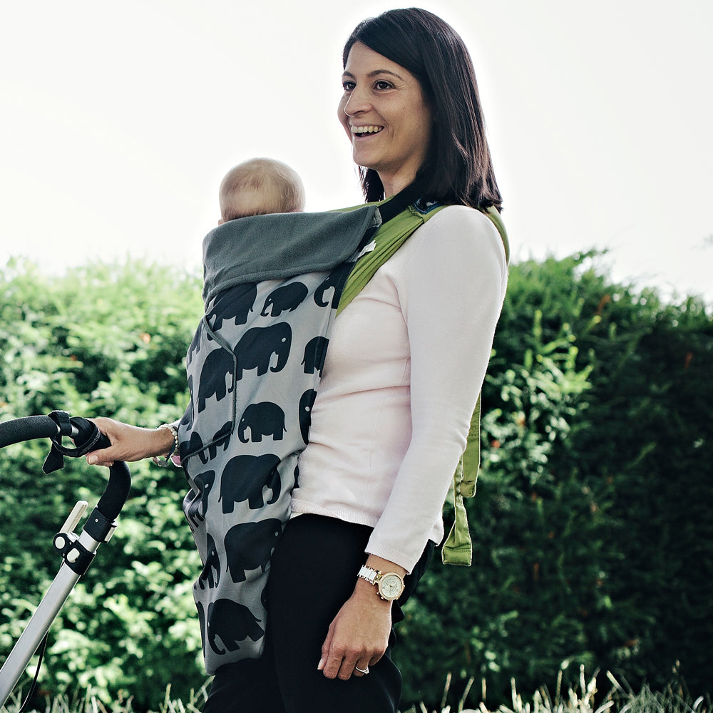 The BundleBean GO is a waterproof footmuff for babies and toddlers that fits snugly on to buggies, bike seats, car seats and baby carriers. Seen here on a baby carrier and in an elephant design