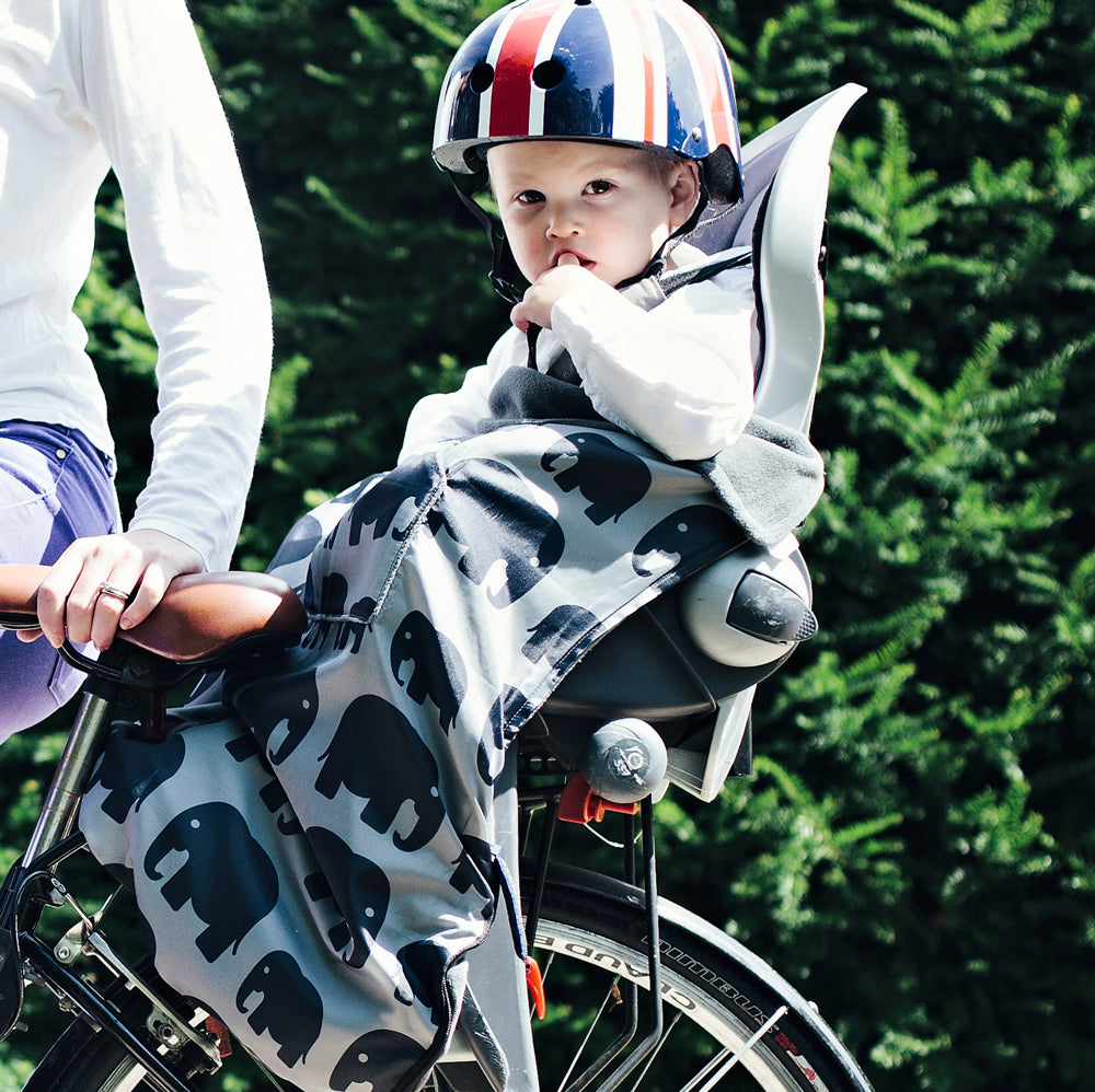 The BundleBean GO is a waterproof footmuff for babies and toddlers that fits snugly on to buggies, bike seats, car seats and baby carriers. Seen here on a bike seat and in an elephant design
